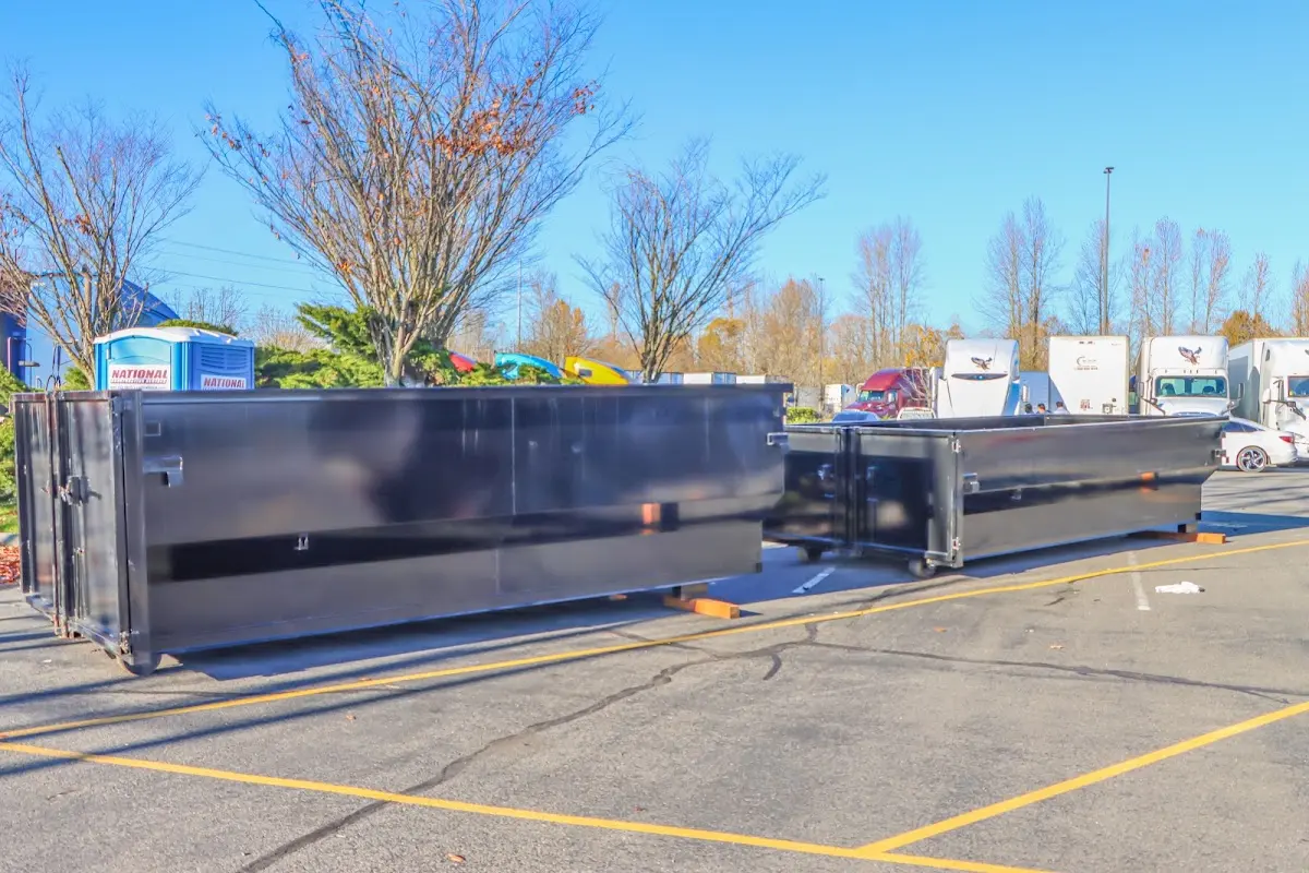 Professional dumpster rental service with roll-off container on residential driveway in Lakeside